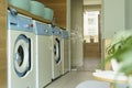 Laundry room interior. Washing machines and dryers in a bright home sunny laundry room.