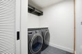 Laundry room with two dryers and a white door Royalty Free Stock Photo
