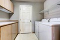 Laundry room with washer and dryer with tile floor. Royalty Free Stock Photo