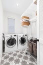A laundry room with white appliances and pattern tile floor. Royalty Free Stock Photo