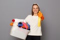 Laundry routine housework task. Washing clothes common household chore. Smiling energetic woman wearing whote t-shirt with laundry