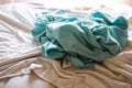 Laundry, Used turquoise crumpled bed sheet on white bed, Selective focus, Bedroom cleaning concept Royalty Free Stock Photo