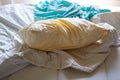 Laundry, Used ivory pillow, Used turquoise crumpled bed sheet on white bed, Selective focus, Bedroom cleaning concept Royalty Free Stock Photo