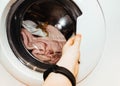 Laundry. wash clothes in the washing machine.getting clothes out of the wash Royalty Free Stock Photo
