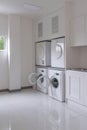 Laundry washing machine and dryer against modern appliance household in laundry room Royalty Free Stock Photo