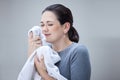 Laundry, woman smelling clean towel and the scent of fresh clothes from washing basket or machine. Housekeeping Royalty Free Stock Photo