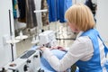 The Laundry worker performs repair of clothing on the sewing machine