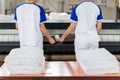 Laundry worker puts ironed textile