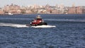 LAURA K. MORAN tugboat in New York Harbor at sunset, Brooklyn skyline in the background