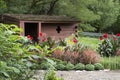 Lauritzen Gardens, Omaha, Nebraska, rustic shed with flowers and shrubs Royalty Free Stock Photo