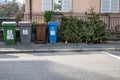 Lausanne, Vaud, Switzerland - 07.01.2021:Abandoned Christmas trees on the pavement beside garbage bin after the holidays