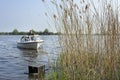 A muskrat fighter sails in his boat