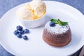 Lava cake - chocolate fondant cake with vanilla ice cream, blueberries and mint. Traditional French pastries. Close-up Royalty Free Stock Photo