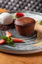 Lava cake with vanilla sauce with fresh strawberries, ice-cream ball Royalty Free Stock Photo