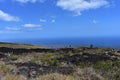 Lava fields on the Big Island in Hawaii with the Pacific Ocean in the background Royalty Free Stock Photo