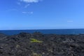 Lava fields on the Big Island in Hawaii with the Pacific Ocean in the background Royalty Free Stock Photo