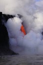 Lava flowing out of cliff suround with white cloud steam Royalty Free Stock Photo