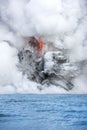 Lava pouring into the ocean in Hawaii Royalty Free Stock Photo