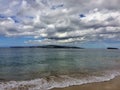 Lava Rock and Coral with Spray of crashing wave in tide pools at Maluaka Beach and Kihei Maui with sky and clouds Royalty Free Stock Photo