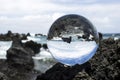 Surf Breaking on Lava Rock Captured in Glass Ball Royalty Free Stock Photo