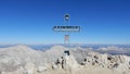 Mountain peak cross with blue sky in the background