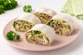 Lavash roll with fish, cheese, eggs and parsley on white background