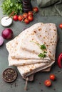 Lavash rolled on a wooden background, thin traditional oriental bread, Armenian flatbread, top view Royalty Free Stock Photo