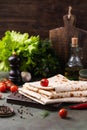 Lavash rolled on a wooden background, thin traditional oriental bread, Armenian flatbread, top view Royalty Free Stock Photo