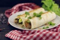 Lavash rolls with meat, vegetables and cheese served with green