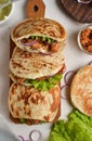 Lavash salad with fried chicken and vegetables. Pita with chicken nuggets, tomatoes, red onions and lettuce and sauce Royalty Free Stock Photo