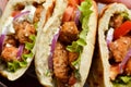 Lavash salad with fried chicken and vegetables. Pita with chicken nuggets, tomatoes, red onions and lettuce and sauce Royalty Free Stock Photo