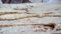 Lavash is a thin flatbread traditionally baked in a tandoor tonir common among the Caucasus, Iran, Afghanistan and Other peopl