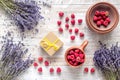 Laveder composition with raspberry in cup and box rustic background top view