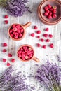 Laveder composition with raspberry in pottery cup rustic background top view