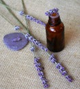 Lavender and bottle of essential oil on sackcloth Royalty Free Stock Photo