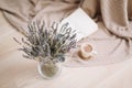 Lavender bouquet with book and cup of coffee on wooden background. spring concept. top view. flatlay