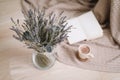 Dried flowers and a cup of cappuccino  with book, spring concept. top view. flatlay Royalty Free Stock Photo