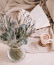 Lavender bouquet with book and cup of coffee on wooden background. spring concept. top view. flatlay. cozy home