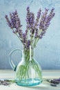 Lavender bouquet in a vintage glass bottle, a nostalgic still life