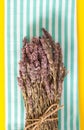 Lavender bundle on folded towel, and vivid yellow background. Royalty Free Stock Photo