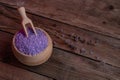 Lavender cooking salt in wooden bowl with spoon on devan background, rustic style Royalty Free Stock Photo