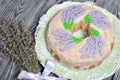 Lavender Cupcake. Sugar coated. Decorated with lavender glaze flowers. Near a bouquet of lavender