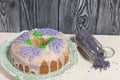 Lavender Cupcake. Sugar coated. Decorated with lavender glaze flowers. Near the bank with lavender inflorescences