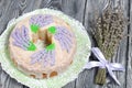 Lavender Cupcake. Sugar coated. Decorated with lavender glaze flowers. Near a bouquet of lavender