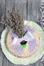 Lavender Cupcake. Sugar coated. Decorated with lavender glaze flowers. Near a bouquet of lavender