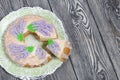 Lavender Cupcake. Sugar coated. Decorated with lavender glaze flowers. A small piece is cut off