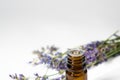 Lavender essential oil in a brown glass bottle with a lavender flowers on white background Royalty Free Stock Photo