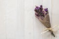 Lavender flower branch bundle dried white wood texture backdrop