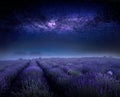 Lavender flowering field and starry sky with milky way, beautiful summer night landscape. Royalty Free Stock Photo