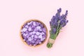 Lavender flowers and bath salt in wooden bowl on pink background. SPA concept. Top view Royalty Free Stock Photo